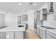 Modern kitchen with stainless steel appliances, white countertops, and gray shaker-style cabinets at 16923 W Siesta Way, Goodyear, AZ 85338