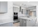 Modern kitchen with stainless steel appliances, white countertops, and shaker style cabinets at 16923 W Siesta Way, Goodyear, AZ 85338