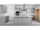 Modern kitchen with stainless steel appliances, white countertops, and shaker style cabinets at 16923 W Siesta Way, Goodyear, AZ 85338