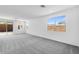 Spacious living room featuring plush carpeting, abundant natural light, and neutral wall colors at 16923 W Siesta Way, Goodyear, AZ 85338