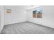 Bright living room boasts neutral gray carpet and large windows at 16923 W Siesta Way, Goodyear, AZ 85338