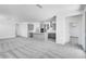 Bright, open-concept living room features gray cabinets and stainless steel appliances in the kitchen at 16923 W Siesta Way, Goodyear, AZ 85338