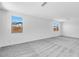 Spacious living room featuring plush carpeting, abundant natural light, and neutral wall colors at 16923 W Siesta Way, Goodyear, AZ 85338