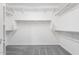 Large walk-in closet featuring built in shelving and rod for ample storage space at 16923 W Siesta Way, Goodyear, AZ 85338