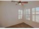 Bright bedroom featuring shuttered windows and a ceiling fan at 27789 N 129Th Ln, Peoria, AZ 85383
