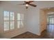 Bedroom showing shuttered windows and a doorway to another room at 27789 N 129Th Ln, Peoria, AZ 85383