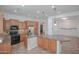 Spacious kitchen featuring wooden cabinets, granite counters, stainless appliances, and large island at 27789 N 129Th Ln, Peoria, AZ 85383