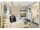 Bright bedroom with two twin beds, patio access, and ample natural light at 27264 N 103Rd Way, Scottsdale, AZ 85262