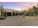 Luxury home with a large driveway and two-car garage, desert landscape, and stunning sunset view at 27264 N 103Rd Way, Scottsdale, AZ 85262