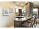 Wet bar with granite countertop and seating at 27264 N 103Rd Way, Scottsdale, AZ 85262
