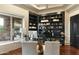 Home office with built-in shelving, large window, and hardwood floors at 27264 N 103Rd Way, Scottsdale, AZ 85262