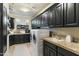 Modern laundry room with dark cabinetry, washer, dryer, and utility sink at 27264 N 103Rd Way, Scottsdale, AZ 85262