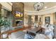 Open living space featuring a stone fireplace and hardwood floors at 27264 N 103Rd Way, Scottsdale, AZ 85262