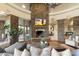 Open living space featuring a stone fireplace and hardwood floors at 27264 N 103Rd Way, Scottsdale, AZ 85262