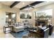 Spacious living room with a fireplace, comfortable seating and large windows at 27264 N 103Rd Way, Scottsdale, AZ 85262