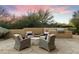Backyard patio with seating area, fire pit, and built-in grill at 27264 N 103Rd Way, Scottsdale, AZ 85262