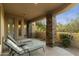 Relaxing patio with lounge chairs and stone columns, offering tranquil views at 27264 N 103Rd Way, Scottsdale, AZ 85262