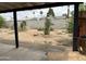 View of the backyard featuring a large block wall, landscaping, and mature trees at 4232 W Citrus Way, Phoenix, AZ 85019