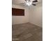 Clean bedroom with tile flooring, a ceiling fan, and a window for natural light at 4232 W Citrus Way, Phoenix, AZ 85019