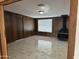 Open concept room features wood paneled walls, fireplace and view of the outdoors at 4232 W Citrus Way, Phoenix, AZ 85019