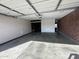 View of the attached garage featuring an automatic door and brick accent wall at 4232 W Citrus Way, Phoenix, AZ 85019
