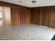 The living room is tiled with brick accent walls and wood paneling at 4232 W Citrus Way, Phoenix, AZ 85019