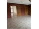 The living room is tiled with brick accent walls and wood paneling at 4232 W Citrus Way, Phoenix, AZ 85019