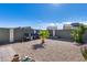 Gravel backyard with seating area and desert plants at 30423 W Catalina Dr, Buckeye, AZ 85396