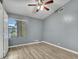 Bedroom with gray walls, laminate flooring, and a window with blinds at 916 E Beautiful Ln, Phoenix, AZ 85042