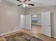 Spacious bedroom with hardwood floors, ceiling fan, and doorway to another room at 916 E Beautiful Ln, Phoenix, AZ 85042