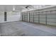 Bright and spacious garage with shelving and two paneled garage doors at 916 E Beautiful Ln, Phoenix, AZ 85042
