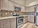 Well-equipped kitchen with stainless steel appliances and granite countertops at 916 E Beautiful Ln, Phoenix, AZ 85042
