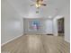 Living room with laminate flooring, ceiling fan, and access to other rooms at 916 E Beautiful Ln, Phoenix, AZ 85042