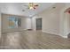 Open living room with laminate flooring, an accent wall, and natural light at 916 E Beautiful Ln, Phoenix, AZ 85042