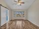 Spacious living room with wood-look floors and barn door at 916 E Beautiful Ln, Phoenix, AZ 85042
