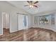 Main bedroom with wood-look floors, barn door, and bay window at 916 E Beautiful Ln, Phoenix, AZ 85042