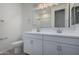 A bathroom featuring a double sink vanity with modern fixtures and a large mirror at 18605 E Panchito Dr, Gold Canyon, AZ 85118