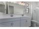 A bright bathroom featuring a double sink vanity with modern fixtures and a walk-in shower at 18605 E Panchito Dr, Gold Canyon, AZ 85118