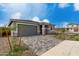 Inviting single-story home showcasing a gray garage door and a beautifully paved driveway at 18605 E Panchito Dr, Gold Canyon, AZ 85118