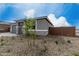 Stylish single-story home with stone accents, well-kept landscaping, and neutral color palette at 18605 E Panchito Dr, Gold Canyon, AZ 85118