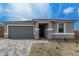 Attractive home featuring a gray garage door, stucco siding, and stylish stone accents at 18605 E Panchito Dr, Gold Canyon, AZ 85118