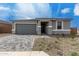 Charming single-story home features a gray brick driveway and stucco exterior with stone accents at 18605 E Panchito Dr, Gold Canyon, AZ 85118