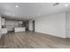 Open living room featuring modern flooring and views of the kitchen and doorway at 18605 E Panchito Dr, Gold Canyon, AZ 85118