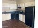 Functional kitchen with white cabinetry and black appliances at 4147 W Reade Ave, Phoenix, AZ 85019