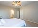 Bright bedroom with ceiling fan, en-suite bathroom access, and carpet flooring at 1406 W Main St # 120, Mesa, AZ 85201