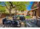 Lush backyard with a covered patio, stylish lounge furniture, and a sparkling pool, ideal for relaxation and enjoyment at 1416 E Sapium Way, Phoenix, AZ 85048