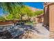 Inviting backyard with a covered patio, artificial turf, and refreshing pool, perfect for outdoor enjoyment at 1416 E Sapium Way, Phoenix, AZ 85048