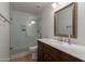 Bathroom featuring glass shower with built-in niche, a wood vanity, and neutral finishes at 1416 E Sapium Way, Phoenix, AZ 85048