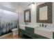 Stylish bathroom with double farmhouse sinks, ornate mirrors, and nature-themed shower curtain at 1416 E Sapium Way, Phoenix, AZ 85048