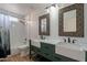 Modern bathroom with double vanity, decorative mirrors, and a shower-tub combination at 1416 E Sapium Way, Phoenix, AZ 85048